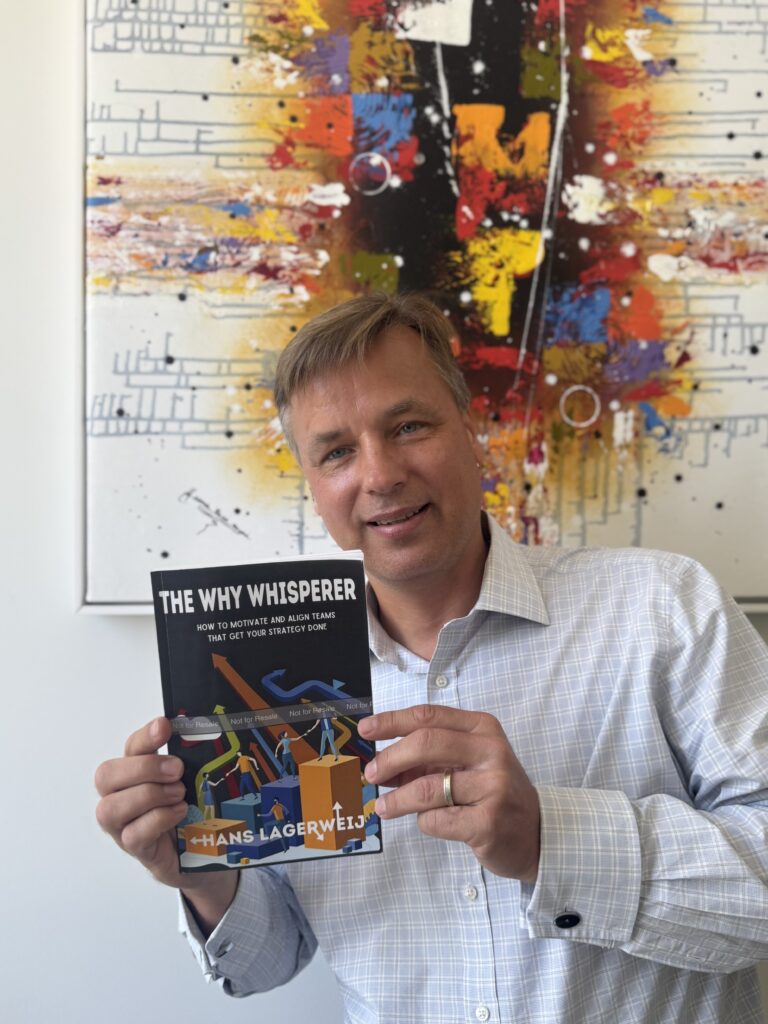 Author Hans Lagerweij holding a copy of his book, "The Why Whisperer."